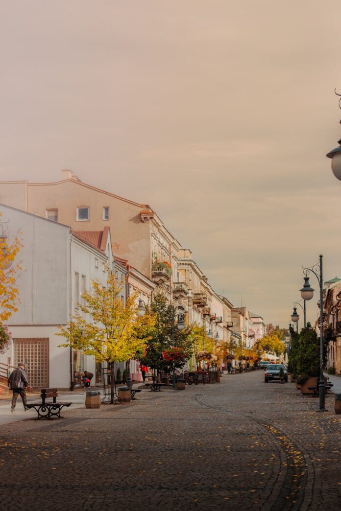 Scenic view of a picturesque street in Radom, Poland during autumn with vibrant foliage.