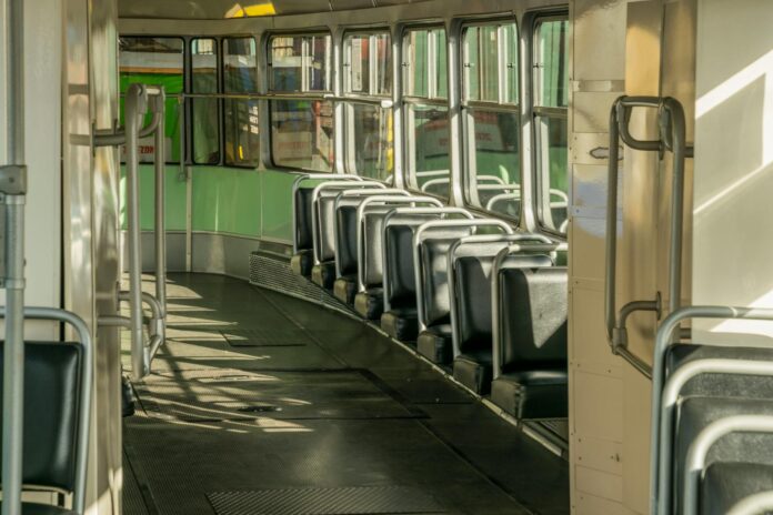 Interior shot of an empty tram in Wrocław, showcasing seats and windows in daylight.